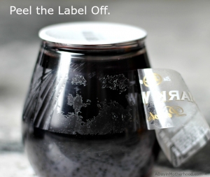 Remove the label to start the glitter wine glasses craft.