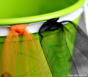 Tie the tulle around the elastic in alternating colors for your No Sew Halloween Basket