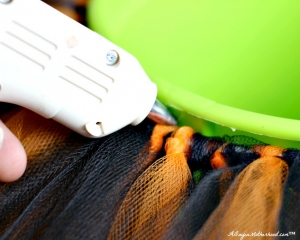 Use a glue gin to make the elastic sturdy in your No Sew Halloween Basket