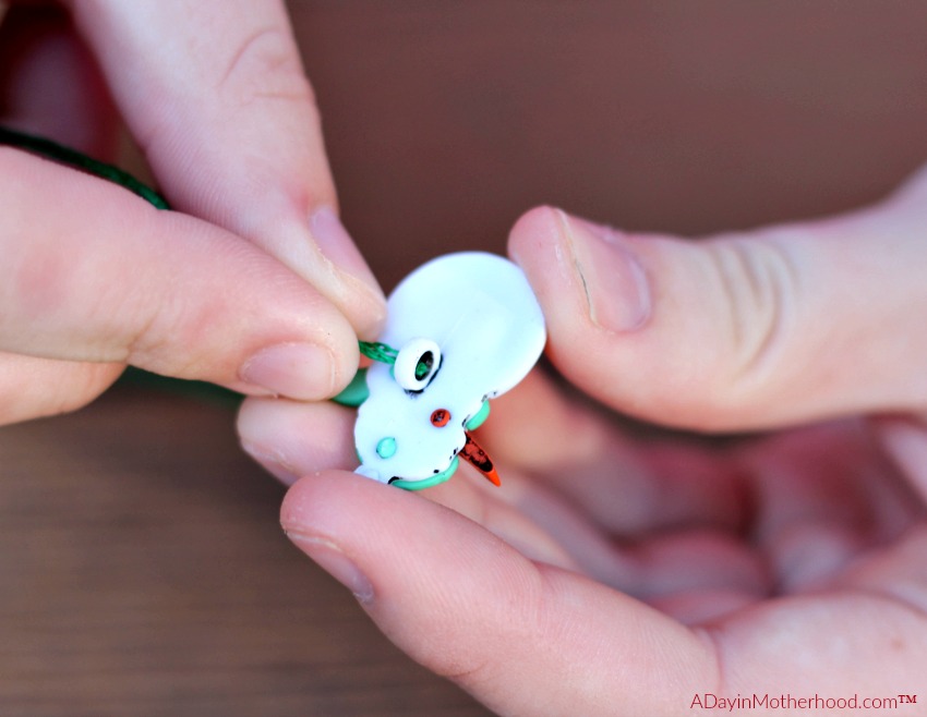 Feed the string through the back of the bauble for your DIY Holiday Napkin Rings