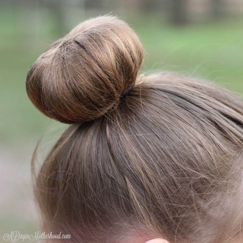 The hairnet keeps the shorter hair for the Easy Princess Updo contianed