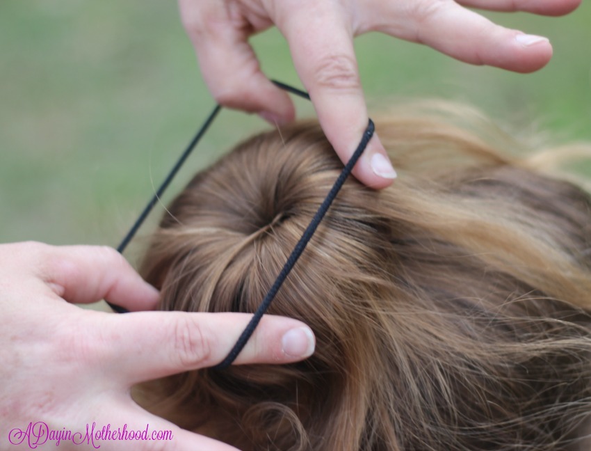 Lock the hair over in the Easy Princess Updo for Kids