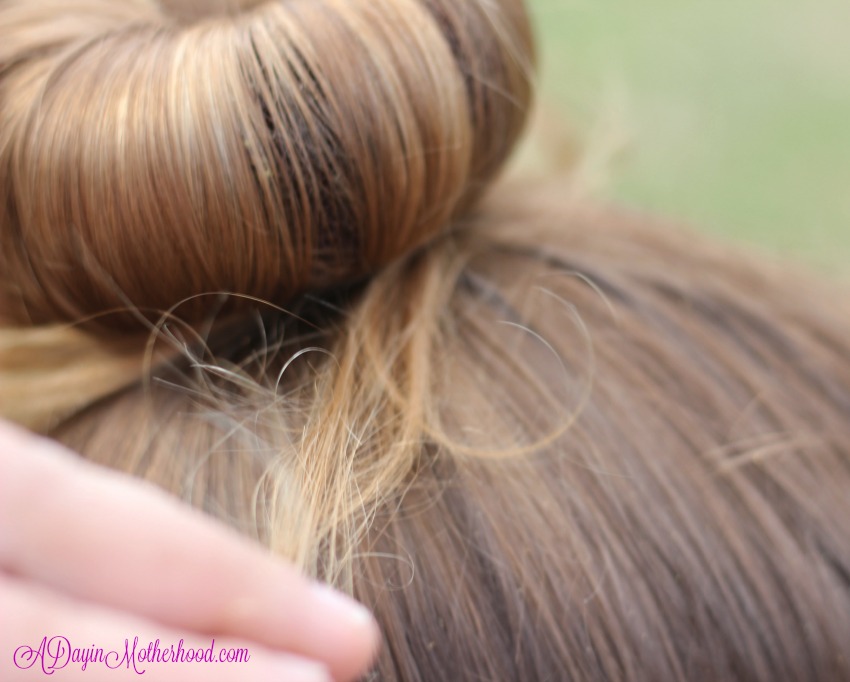 Gently pull the hair around the bun for the Easy Princess Updo for Kids