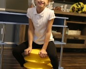 ErgoErgo and Tossits to help me get moving in the New Year-girl on yellow stool on adayinmotherhood.com