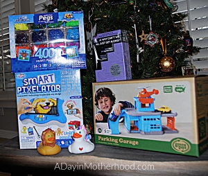 Best Toys for the New Year-photo of gifts next to tree on ADayinMotherhood.com