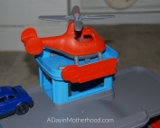 Best Toys for the New Year-photo of helicopter on top of toy garage on ADayinMotherhood.com