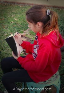 WOW! Stuff for The Wizarding World-a photo of girl reading journal on ADayinmotherhood.com